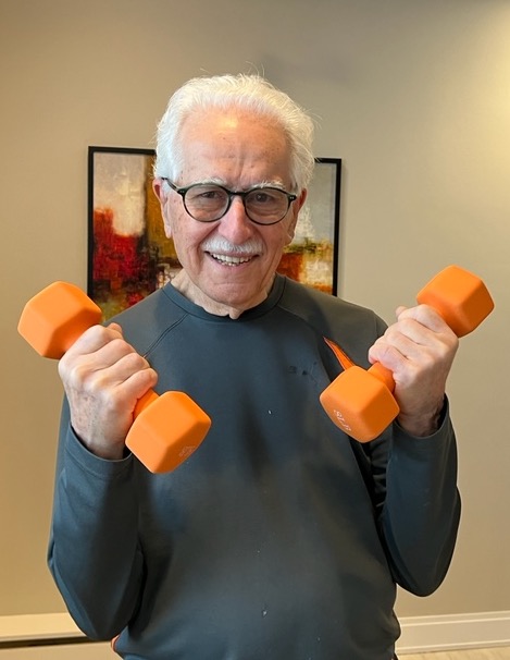 Senior man lifting weights.