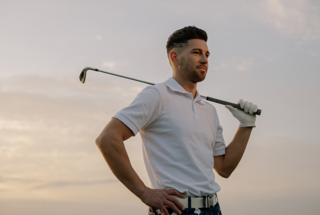 Fit man holding a golf club.