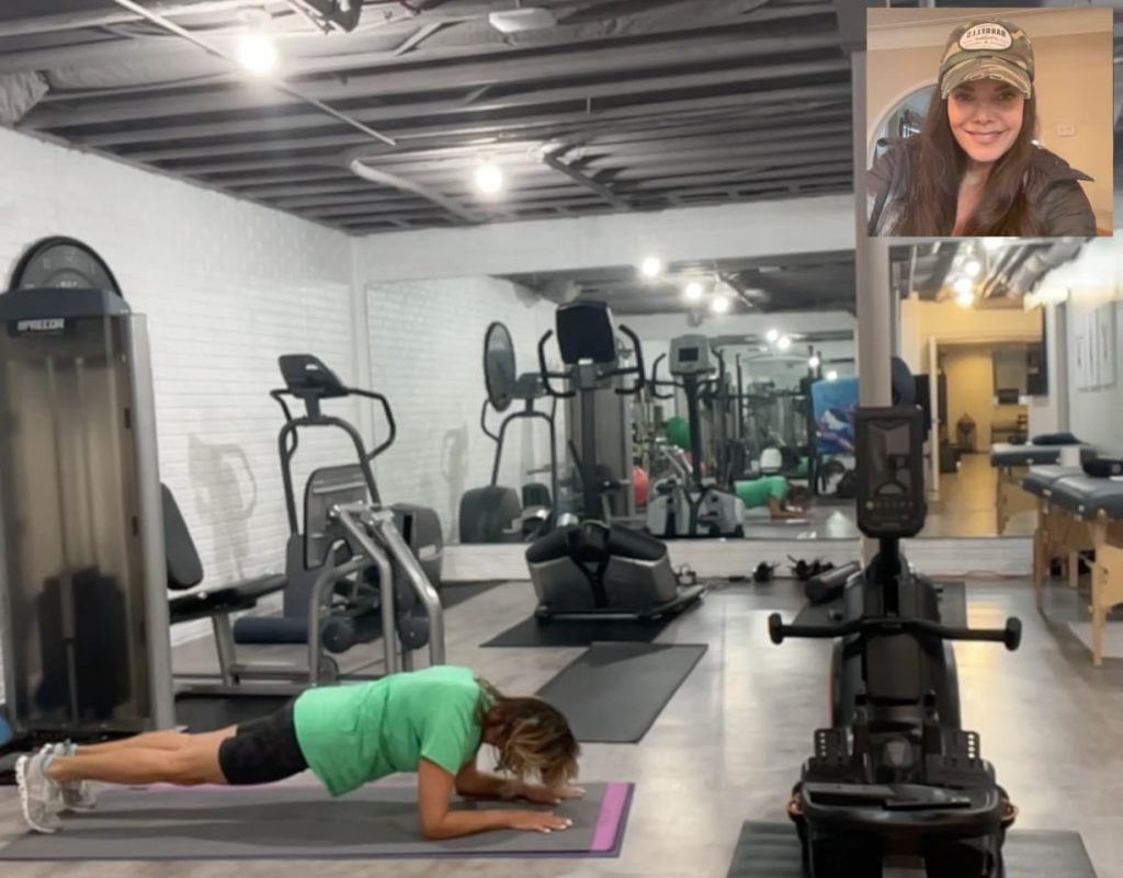 Woman working out at home with a Virtual personal Trainer.