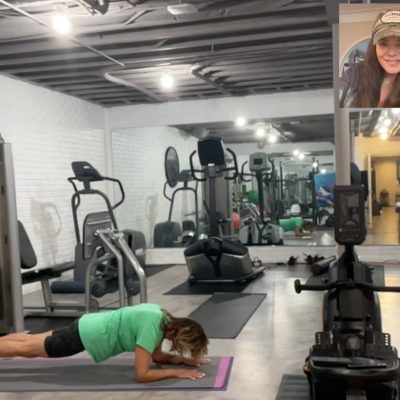 Woman working out at home with a Virtual personal Trainer.