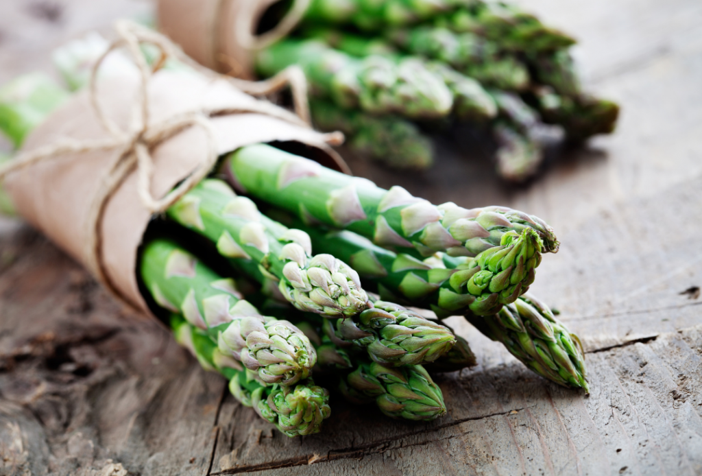 Beautiful bunch of asparagus wrapped in paper and twine.