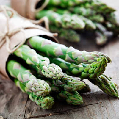 Beautiful bunch of asparagus wrapped in paper and twine.