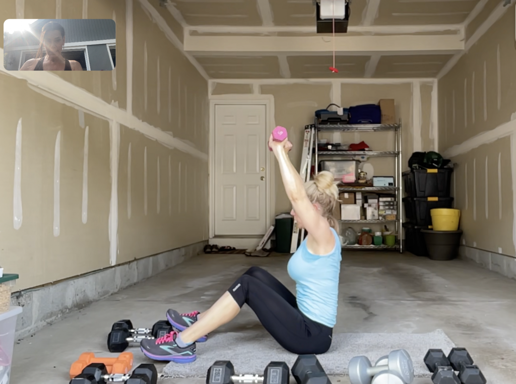 Woman working out in her garage with weights.