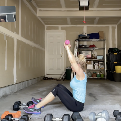 Woman working out in her garage with weights.