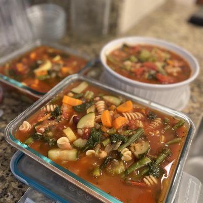 Minestrone soup with lots of vegetables in containers.