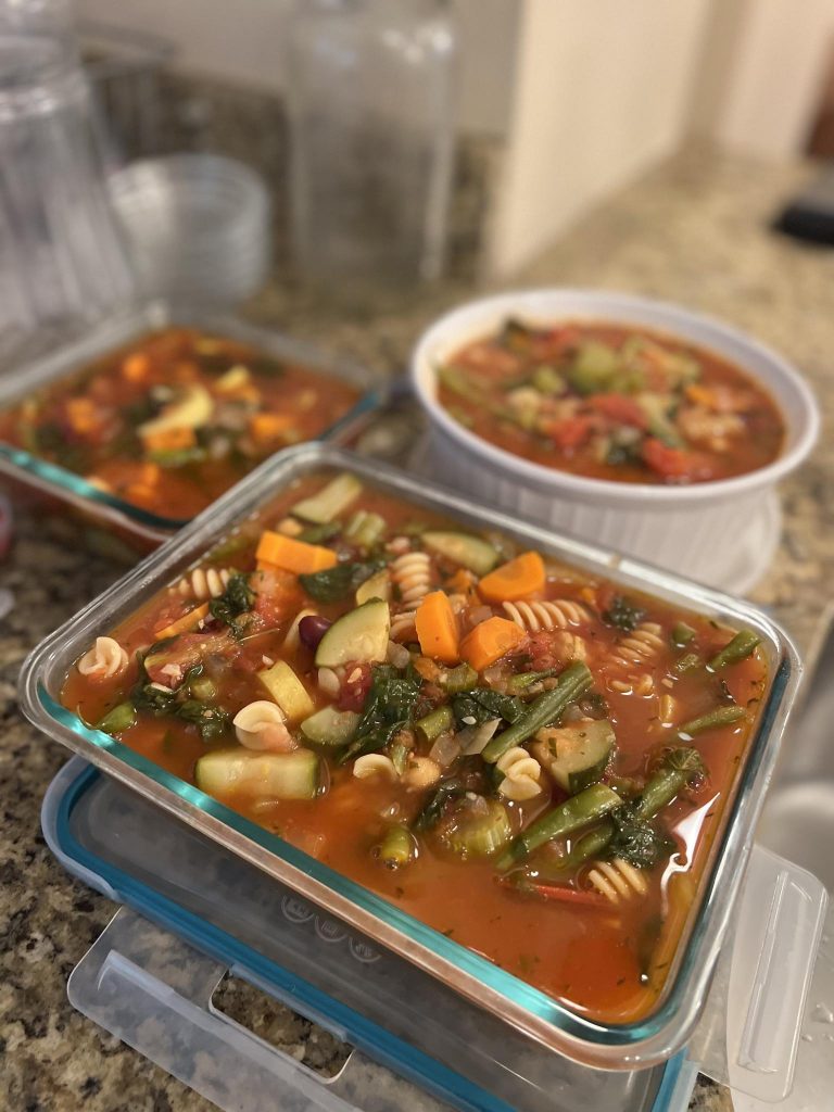 Minestrone soup with lots of vegetables in containers.