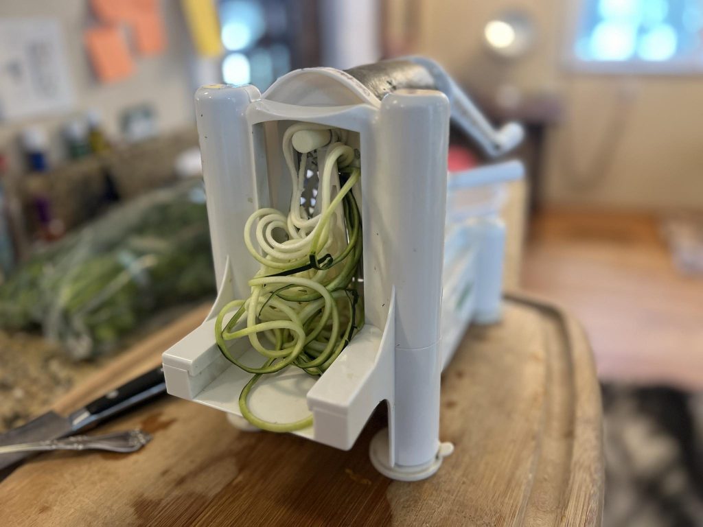 Spiralizer kitchen tool making zucchini noodles.