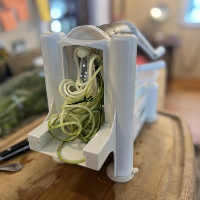 Spiralizer kitchen tool making zucchini noodles.